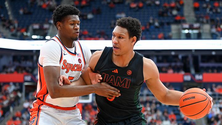 Jan 24, 2026; Syracuse, New York, USA; Miami Hurricanes forward Malik Reneau (right) drives against Syracuse Orange forward Tyler Betsey (left) during the first half at the JMA Wireless Dome. Mandatory Credit: Rich Barnes-Imagn Images