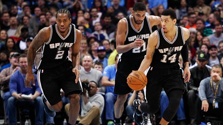 Dec 14, 2014; Denver, CO, USA; San Antonio Spurs guard Danny Green (14) dribbles the ball up court with forward Kawhi Leonard (2) and forward Tim Duncan (21) in the third quarter against the Denver Nuggets at Pepsi Center. The San Antonio Spurs defeated the Denver Nuggets 99-91. Mandatory Credit: Isaiah J. Downing-Imagn Images