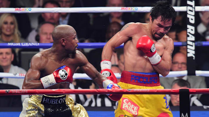 Floyd Mayweather (black/gold trunks) and Manny Pacquiao (yellow/red trunks) box on May 2, 2015 Floyd Mayweather (black/gold trunks) and Manny Pacquiao (yellow/red trunks) box on May 2, 2015