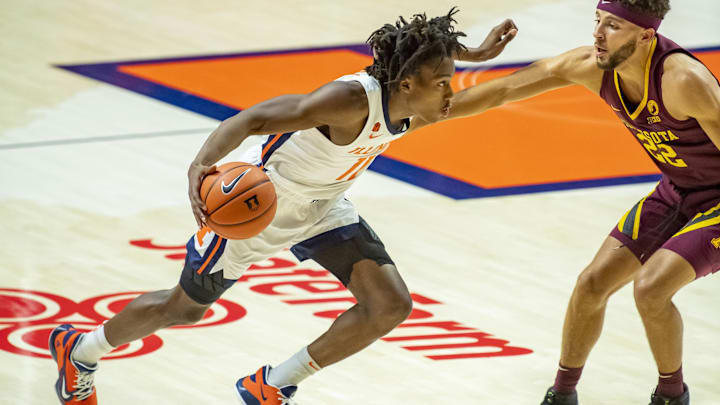 Dec 15, 2020; Champaign, Illinois, USA; Illinois Fighting Illini guard Ayo Dosunmu (11) drives against Minnesota Golden Gophers guard Gabe Kalscheur (22) during the first half at the State Farm Center. Mandatory Credit: Patrick Gorski-Imagn Images Dec 15, 2020; Champaign, Illinois, USA; Illinois Fighting Illini guard Ayo Dosunmu (11) drives against Minnesota Golden Gophers guard Gabe Kalscheur (22) during the first half at the State Farm Center. Mandatory Credit: Patrick Gorski-Imagn Images