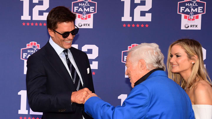 Jun 12, 2024; Foxborough, MA, USA; Tom Brady fist bumps during the New England Patriots Hall oner Robert Kraft at the Patriots Hall Fame induction Ceremony for Tom Brady Mandatory Credit: Eric Canha-USA TODAY Sports Jun 12, 2024; Foxborough, MA, USA; Tom Brady fist bumps during the New England Patriots Hall oner Robert Kraft at the Patriots Hall Fame induction Ceremony for Tom Brady Mandatory Credit: Eric Canha-USA TODAY Sports