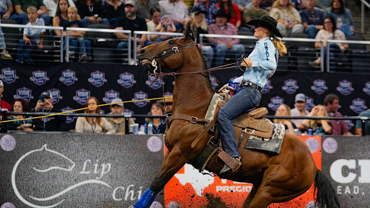 Rylee George stopping her horse in the breakaway roping.