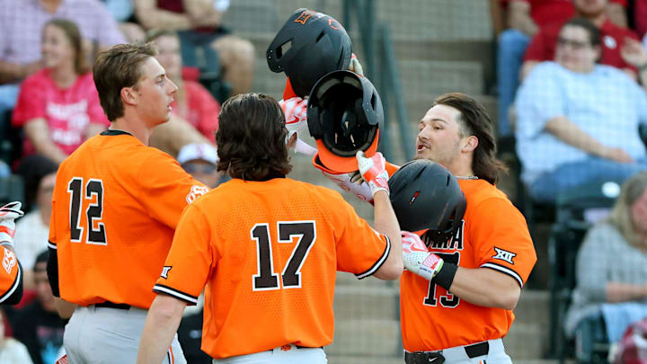 Oklahoma State's Kollin Ritchie (right) celebrates a home run with Colin Brueggemann and Tyler Wulfert.