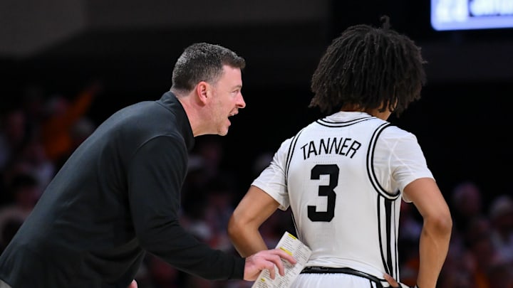 Feb 21, 2026; Nashville, Tennessee, USA;  Vanderbilt Commodores head coach Mark Byington talks with guard Tyler Tanner (3) against the Tennessee Volunteers during the second half at Memorial Gymnasium. Mandatory Credit: Steve Roberts-Imagn Images