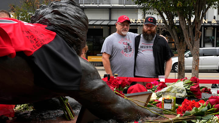 Paul Fernandez, left, of Ross, and his son Pete Fernandez, Northside, pay their respects at the statue of Rose sliding into home at the entrance of Great American Ballpark, Tuesday, Oct. 1, 2024. As word spread of the death of former Cincinnati Reds player/manager, Pete Rose at 83, many came downtown to GABP. Paul was witness to Rose’s 4,192 hit on Sept. 11, 1985. His son is named after Pete Rose. The statue was installed in 2017. Rose died at his home in Nevada, Sept. 30, 2024. Paul Fernandez, left, of Ross, and his son Pete Fernandez, Northside, pay their respects at the statue of Rose sliding into home at the entrance of Great American Ballpark, Tuesday, Oct. 1, 2024. As word spread of the death of former Cincinnati Reds player/manager, Pete Rose at 83, many came downtown to GABP. Paul was witness to Rose’s 4,192 hit on Sept. 11, 1985. His son is named after Pete Rose. The statue was installed in 2017. Rose died at his home in Nevada, Sept. 30, 2024.