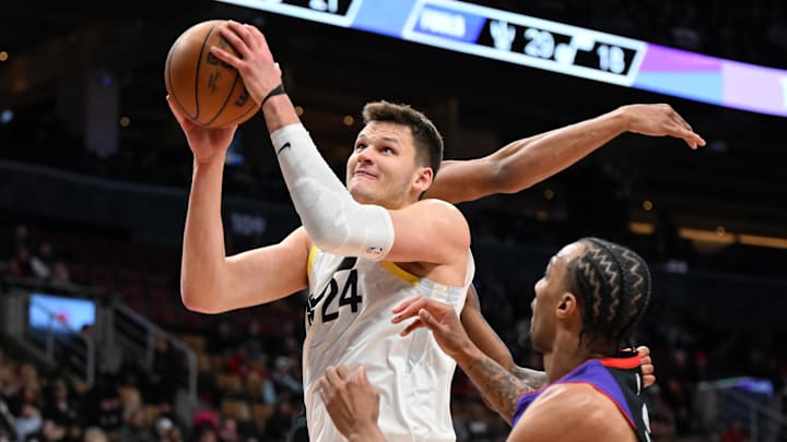 Mar 7, 2025; Toronto, Ontario, CAN;  Utah Jazz center Walker Kessler (24) goes in for a layup over Toronto Raptors guard AJ Lawson (0) in the second half at Scotiabank Arena. Mandatory Credit: Dan Hamilton-Imagn Images