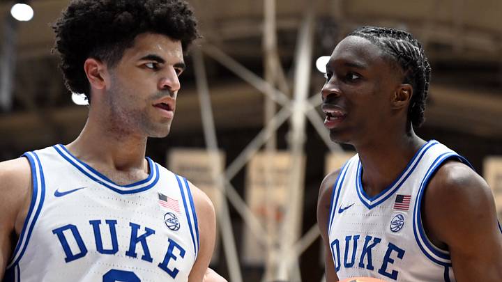 Mar 7, 2026; Durham, North Carolina, USA;Duke Blue Devils guard Cayden Boozer (2) and forward Dame Sarr (right) strategize during the second half against the North Carolina Tar Heels at Cameron Indoor Stadium.  The Duke Blue Devils won 76-61. Mandatory Credit: Rob Kinnan-Imagn Images