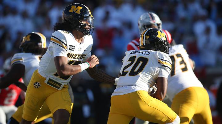 Oct 17, 2026; Oxford, Mississippi, USA; Missouri Tigers quarterback Austin Simmons (13) hands off to running back Jamal Roberts (20) during the second half against the Mississippi Rebels at Vaught-Hemingway Stadium. Mandatory Credit: Petre Thomas-Imagn Images Oct 17, 2026; Oxford, Mississippi, USA; Missouri Tigers quarterback Austin Simmons (13) hands off to running back Jamal Roberts (20) during the second half against the Mississippi Rebels at Vaught-Hemingway Stadium. Mandatory Credit: Petre Thomas-Imagn Images