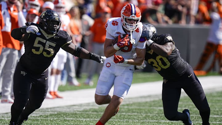 Oct 12, 2024; Winston-Salem, North Carolina, USA; Clemson Tigers tight end Jake Briningstool (9) tries to elude Wake Forest Demon Deacons defensive lineman Bryce Ganious (55) and defensive lineman Jasheen Davis (30) during the second half at Allegacy Federal Credit Union Stadium. 