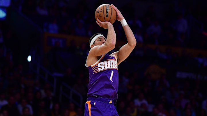 Dec 1, 2025; Los Angeles, California, USA; Phoenix Suns guard Devin Booker (1) shoots against the Los Angeles Lakers during the first half at Crypto.com Arena. Mandatory Credit: Gary A. Vasquez-Imagn Images