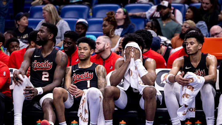Mar 16, 2024; New Orleans, Louisiana, USA;  Portland Trail Blazers guard Anfernee Simons (1) and center Deandre Ayton (2) on the bench in the final few minutes of the game against the New Orleans Pelicans during the second half at Smoothie King Center. Mandatory Credit: Stephen Lew-Imagn Images