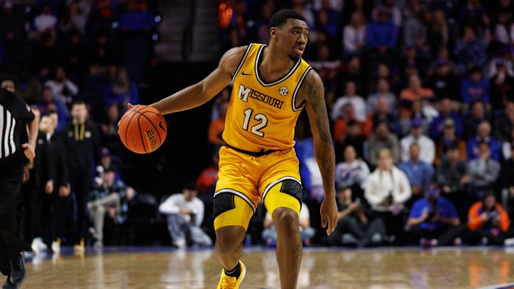 Jan 14, 2025; Gainesville, Florida, USA; Missouri Tigers guard Tony Perkins (12) dribbles the ball against the Florida Gators during the first half at the Stephen C. O'Connell Center in Gainesville, FL on Tuesday, January 14, 2025. Mandatory Credit: Matt Pendleton-Imagn Images Jan 14, 2025; Gainesville, Florida, USA; Missouri Tigers guard Tony Perkins (12) dribbles the ball against the Florida Gators during the first half at the Stephen C. O'Connell Center in Gainesville, FL on Tuesday, January 14, 2025. Mandatory Credit: Matt Pendleton-Imagn Images