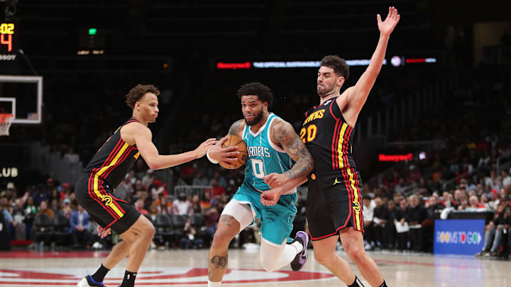 Mar 12, 2025; Atlanta, Georgia, USA; Charlotte Hornets forward Miles Bridges (0) tries to work past Atlanta Hawks forward Georges Niang (20) and guard Dyson Daniels (5) during the second half at State Farm Arena. Mandatory Credit: Mady Mertens-Imagn Images Mar 12, 2025; Atlanta, Georgia, USA; Charlotte Hornets forward Miles Bridges (0) tries to work past Atlanta Hawks forward Georges Niang (20) and guard Dyson Daniels (5) during the second half at State Farm Arena. Mandatory Credit: Mady Mertens-Imagn Images