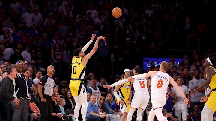 May 19, 2024; New York, New York, USA; Indiana Pacers guard Tyrese Haliburton (0) shoots a three point shot against New York Knicks guards Jalen Brunson (11) and Donte DiVincenzo (0) during the third quarter of game seven of the second round of the 2024 NBA playoffs at Madison Square Garden. Mandatory Credit: Brad Penner-Imagn Images
