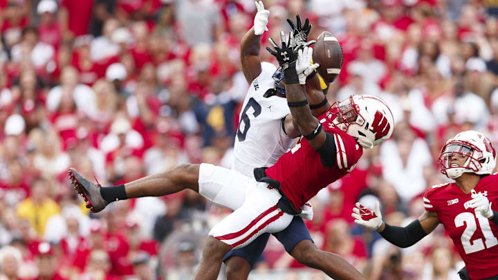 Oct 2, 2021; Madison, Wisconsin, USA;  Wisconsin Badgers cornerback Faion Hicks (1) defends the pass intended for Michigan Wolverines wide receiver Cornelius Johnson (6) during the second quarter at Camp Randall Stadium.