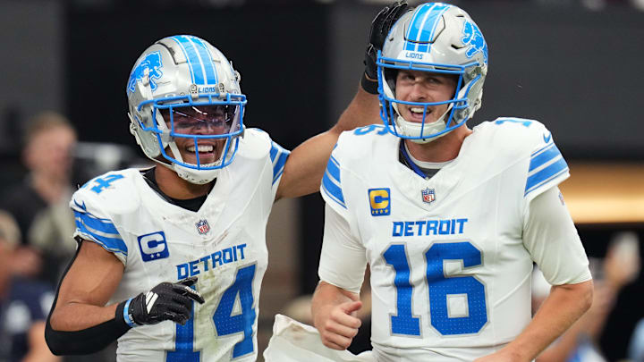 Detroit Lions receiver Amon-Ra St. Brown (14) and quarterback Jared Goff (16) celebrate after completing a hook and ladder play for a touchdown to teammate Jahmyr Gibbs (not pictured) during their game against the Arizona Cardinals at State Farm Stadium in Glendale, Ariz., Sep 22, 2024.