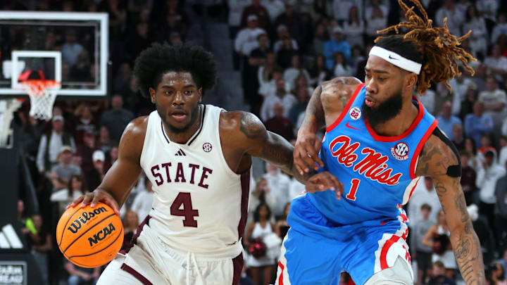 Jan 18, 2025; Starkville, Mississippi, USA; Mississippi State Bulldogs forward Cameron Matthews (4) drives to the basket as Mississippi Rebels forward Mikeal Brown-Jones (1) defends during over-time at Humphrey Coliseum. Mandatory Credit: Petre Thomas-Imagn Images