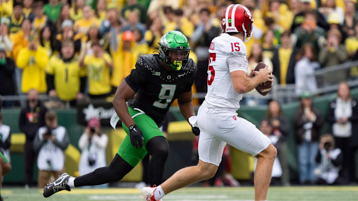 Oregon outside linebacker Blake Purchase pressures Indiana quarterback Fernando Mendoza as the Oregon Ducks host the Indiana Hoosiers Oct. 11, 2025, at Autzen Stadium in Eugene, Oregon.