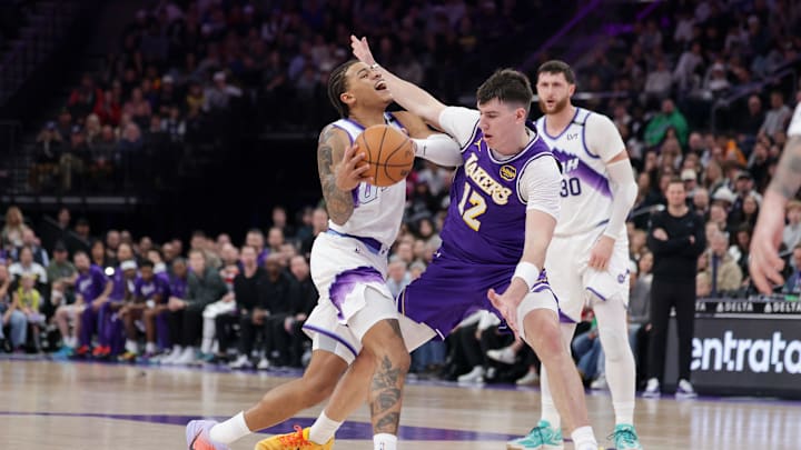 Dec 18, 2025; Salt Lake City, Utah, USA;  Utah Jazz guard Keyonte George (3) is fouled by Los Angeles Lakers forward Jake Laravia (12) during the second half at Delta Center. Mandatory Credit: Chris Nicoll-Imagn Images