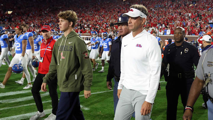 Nov 15, 2025; Oxford, Mississippi, USA; Mississippi Rebels head coach Lane Kiffin and his son, Knox Kiffin, walk onto the field after defeating the Florida Gators at Vaught-Hemingway Stadium. Mandatory Credit: Petre Thomas-Imagn Images