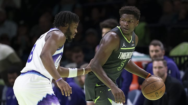 Nov 7, 2025; Minneapolis, Minnesota, USA; Minnesota Timberwolves guard Anthony Edwards (5) dribbles the ball as Utah Jazz guard Isaiah Collier (8) plays defense in the first half at Target Center. Mandatory Credit: Jesse Johnson-Imagn Images