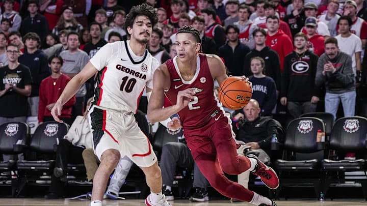 Jan 10, 2024; Athens, Georgia, USA; Arkansas Razorbacks forward Trevon Brazile (2) dribbles past Georgia Bulldogs guard RJ Sunahara (10) at Stegeman Coliseum. Mandatory Credit: Dale Zanine-USA TODAY Sports