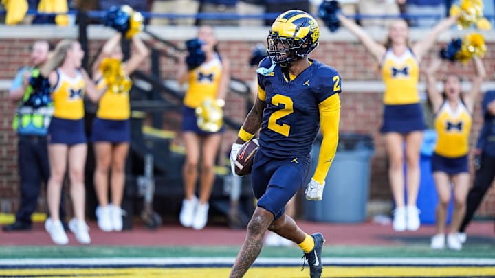 Michigan defensive back Will Johnson celebrates a touchdown after intercepting USC quarterback Miller Moss during the second half at Michigan Stadium in Ann Arbor on Saturday, Sept. 21, 2024.