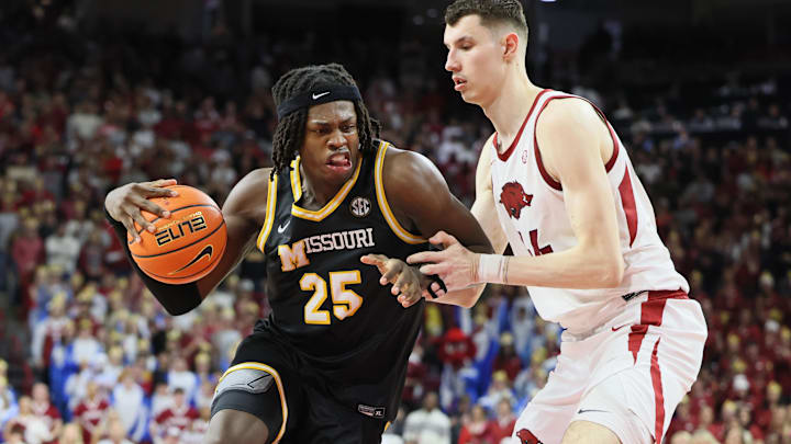 Feb 22, 2025; Fayetteville, Arkansas, USA; Missouri Tigers forward Mark Mitchell (25) drives against Arkansas Razorbacks forward Zvonimir Ivisic (44) during the second half at Bud Walton Arena. Mandatory Credit: Nelson Chenault-Imagn Images