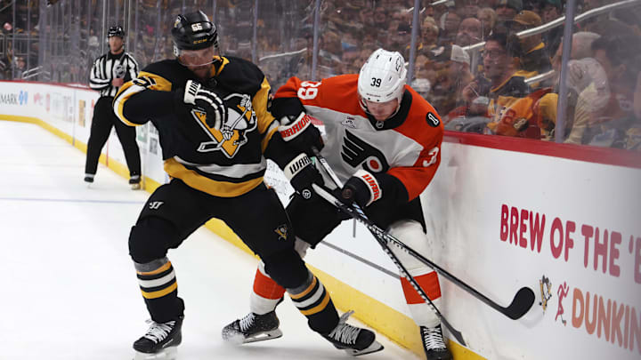 Mar 7, 2026; Pittsburgh, Pennsylvania, USA;  Pittsburgh Penguins defenseman Erik Karlsson (65) and Philadelphia Flyers right wing Matvei Michkov (39) battle for the puck during the third period at PPG Paints Arena.