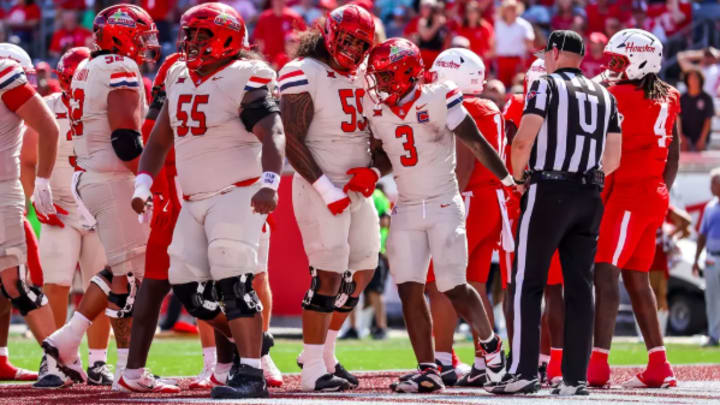 Running back Kedrick Reescano celebrating a touchdown with his offensive linemen Running back Kedrick Reescano celebrating a touchdown with his offensive linemen