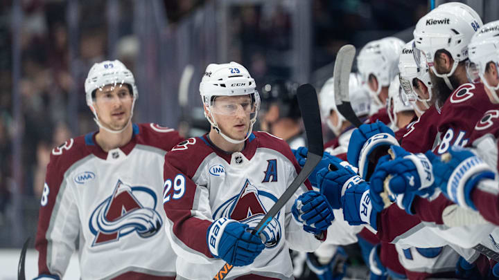 Mar 12, 2026; Seattle, Washington, USA; Colorado Avalanche forward Nathan MacKinnon (29) celebrates a goal with teammates on the bench during the first period against the Seattle Kraken at Climate Pledge Arena. Mandatory Credit: Stephen Brashear-Imagn Images