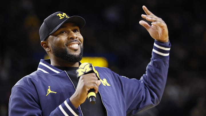 Jan 19, 2025; Ann Arbor, Michigan, USA;  Michigan Wolverines head football coach Sherrone Moore fires up the crowd in overtime of the basketball game against the Northwestern Wildcats at Crisler Center.