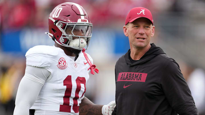 Alabama Crimson Tide head coach Kalen Deboer talks with quarterback Austin Mack (10) 