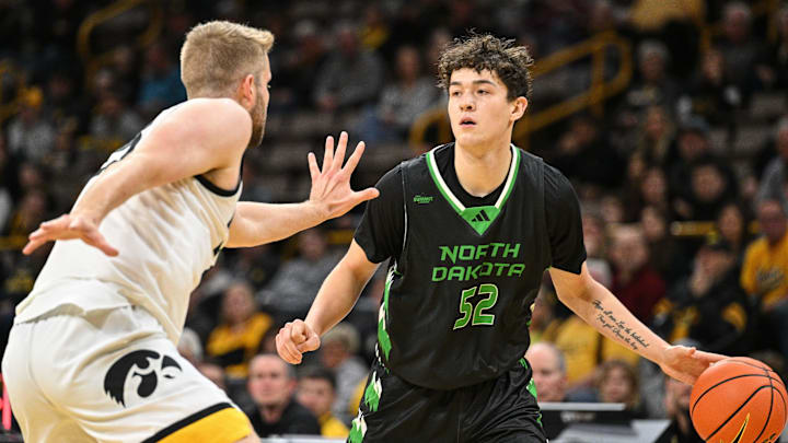 Nov 7, 2023; Iowa City, Iowa, USA; North Dakota Fighting Hawks guard Treysen Eaglestaff (52) dribbles against Iowa Hawkeyes forward Ben Krikke (23) during the first half at Carver-Hawkeye Arena. Mandatory Credit: Jeffrey Becker-Imagn Images Nov 7, 2023; Iowa City, Iowa, USA; North Dakota Fighting Hawks guard Treysen Eaglestaff (52) dribbles against Iowa Hawkeyes forward Ben Krikke (23) during the first half at Carver-Hawkeye Arena. Mandatory Credit: Jeffrey Becker-Imagn Images