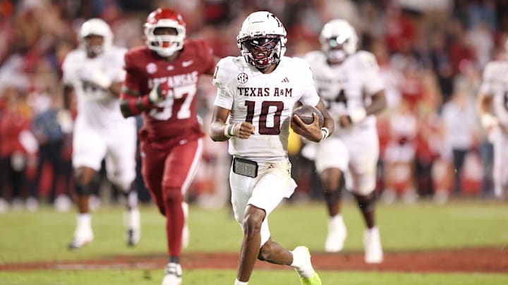 Oct 18, 2025; Fayetteville, Arkansas, USA; Texas A&M Aggies quarterback Marcel Reed (10) rushes for a touchdown that was called back for holding during the fourth quarter against the Arkansas Razorbacks at Donald W. Reynolds Razorback Stadium. Mandatory Credit: Nelson Chenault-Imagn Images