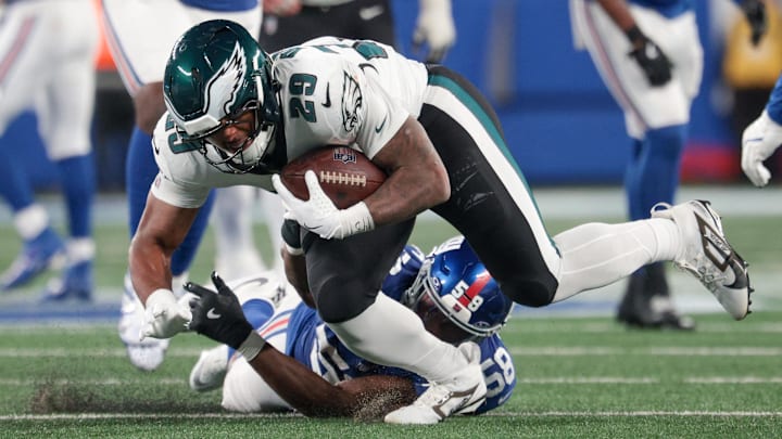 Oct 9, 2025; East Rutherford, New Jersey, USA; Philadelphia Eagles running back AJ Dillon (29) avoids a tackle by New York Giants linebacker Bobby Okereke (58) during the fourth quarter of the game at MetLife Stadium.