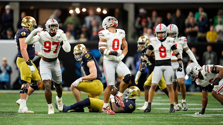 Ohio State Buckeyes linebacker Cody Simon (0) celebrates a tackle of Notre Dame Fighting Irish running back Jeremiyah Love (4) in the first quarter during the College Football Playoff National Championship at Mercedes-Benz Stadium in Atlanta on January 20, 2025.