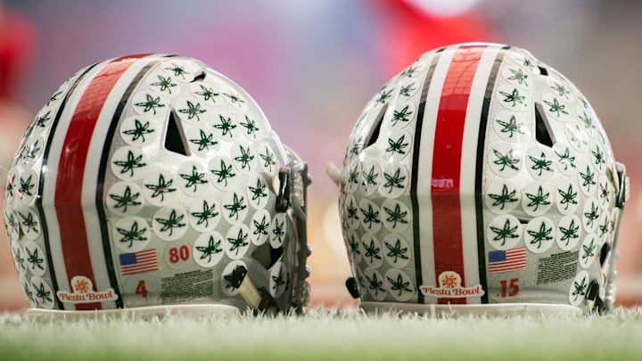 Jan 1, 2016; Glendale, AZ, USA; Two Ohio State Buckeyes helmets sit on the field during warmups before the 2016 Fiesta Bowl between the Notre Dame Fighting Irish and the Ohio State Buckeyesat University of Phoenix Stadium. Mandatory Credit: Matt Cashore-Imagn Images
