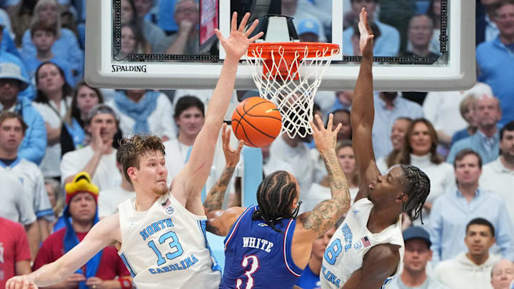 Nov 7, 2025; Chapel Hill, North Carolina, USA;  Kansas Jayhawks guard Tre White (3) shoots as North Carolina Tar Heels center Henri Veesaar (13) and forward Caleb Wilson (8) defend in the second half at Dean E. Smith Center. Mandatory Credit: Bob Donnan-Imagn Images