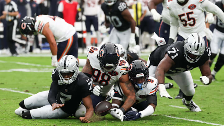 Sep 28, 2025; Paradise, Nevada, USA; Las Vegas Raiders quarterback Geno Smith (7), offensive tackle DJ Glaze (71), Chicago Bears defensive end Montez Sweat (98) and safety Jaquan Brisker (9) scramble for a loose ball after a sack in the first quarter at Allegiant Stadium. Mandatory Credit: Kiyoshi Mio-Imagn Images