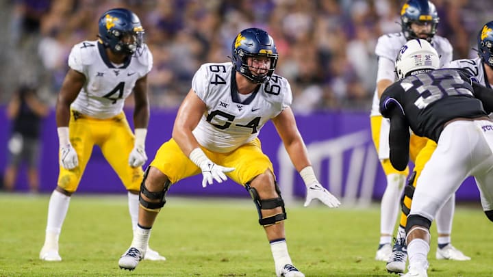Oct 23, 2021; Fort Worth, Texas, USA; West Virginia Mountaineers offensive lineman Wyatt Milum (64) steps back to block during the third quarter against the TCU Horned Frogs at Amon G. Carter Stadium. Mandatory Credit: Ben Queen-Imagn Images