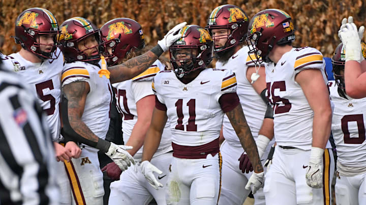 Nov 22, 2025; Chicago, Illinois, USA; Minnesota Golden Gophers wide receiver Javon Tracy (11) celebrates his touchdown with teammates against the Northwestern Wildcats during the first half at Wrigley Field. Mandatory Credit: Patrick Gorski-Imagn Images