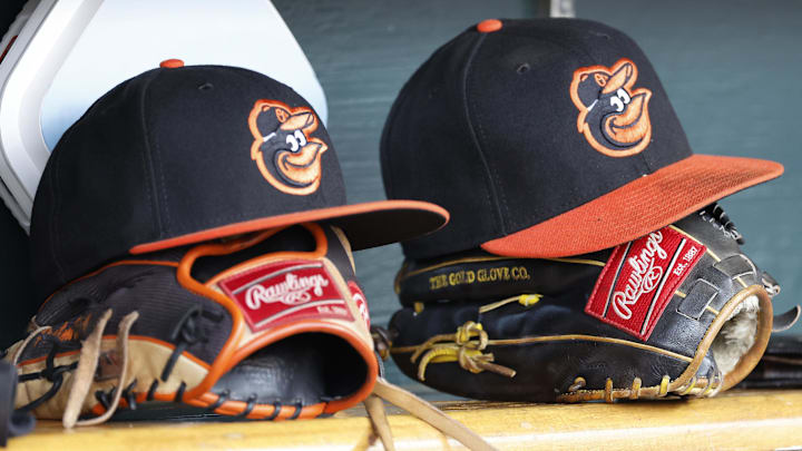 Baltimore Orioles hats and glove sits in dugout Baltimore Orioles hats and glove sits in dugout