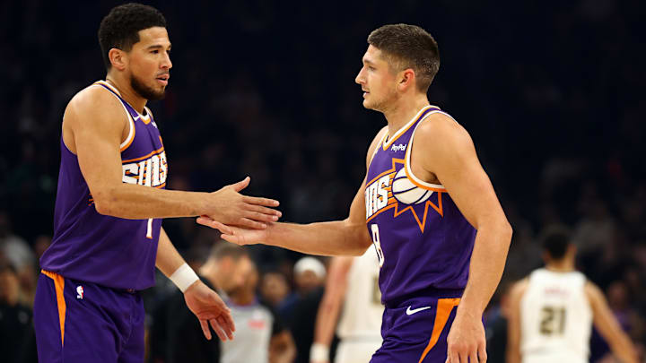 Nov 29, 2025; Phoenix, Arizona, USA; Phoenix Suns guard Devin Booker (left) with Grayson Allen against the Denver Nuggets in the first half at the Mortgage Matchup Center. Mandatory Credit: Mark J. Rebilas-Imagn Images