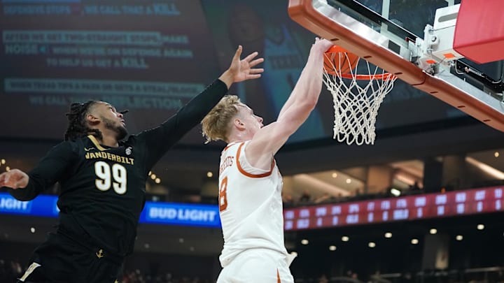 Jan 14, 2026; Austin, Texas, USA; Texas Longhorns center Matas Vokietaitis (8) dunks the ball against Vanderbilt Commodores forward Devin McGlockton (99) during the first half at Moody Center. Mandatory Credit: Dustin Safranek-Imagn Images
