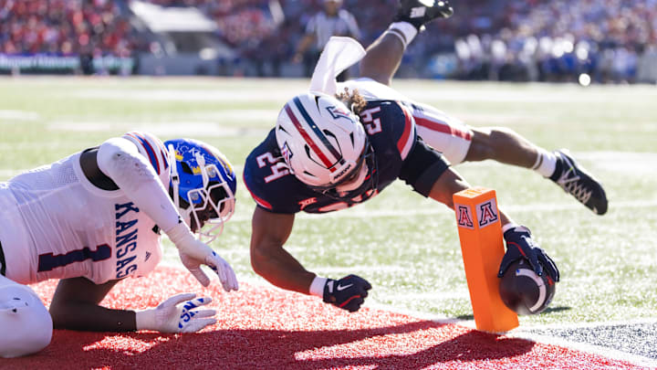 Nov 8, 2025; Tucson, Arizona, USA; Arizona Wildcats running back Quincy Craig (24) dives and reaches for the pylon to score a touchdown against the Kansas Jayhawks in the first half at Arizona Stadium. Mandatory Credit: Mark J. Rebilas-Imagn Images