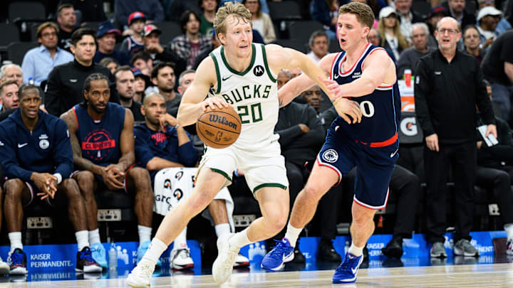 Mar 23, 2026; Inglewood, California, USA; Milwaukee Bucks guard AJ Green (20) drives the ball while under pressure from Los Angeles Clippers guard Sean Pedulla (00) during the second half at Intuit Dome. Mandatory Credit: William Liang-Imagn Images