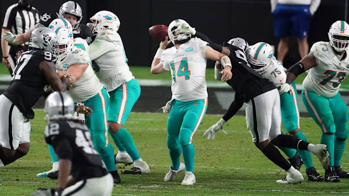 Las Vegas Raiders defensive end Arden Key (99) is called for a facemask penalty against Miami Dolphins quarterback Ryan Fitzpatrick (14) in the final minute at Allegiant Stadium in 2020.