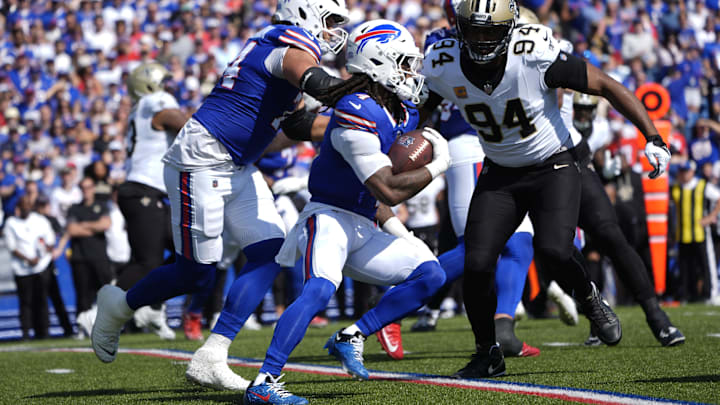 Buffalo Bills running back James Cook runs for a gain past New Orleans Saints defensive end Cameron Jordan.