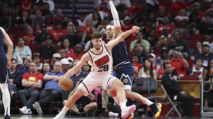 Mar 23, 2025; Houston, Texas, USA; Denver Nuggets forward Aaron Gordon (32) defends against Houston Rockets center Alperen Sengun (28) during the third quarter at Toyota Center. Mandatory Credit: Troy Taormina-Imagn Images